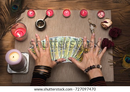 Fortune teller reading future with tarot cards. Paranormal desk table.