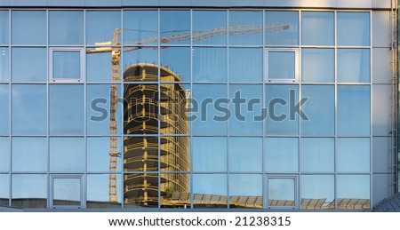 New build construction reflect in the windows of public building