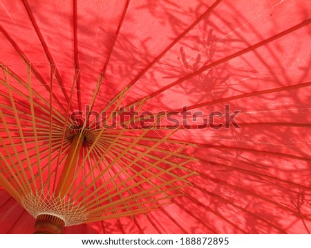 Shadow on a red umbrella