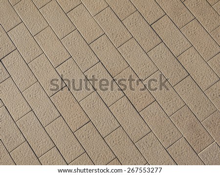 Rough textured stone tiles, exterior walkway, perspective view. Large square slab patterned flooring. Horizontal photo