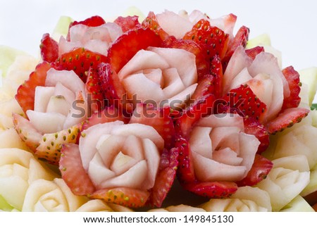 The soft strawberry is intricately carved into a rose and placed along side various fruits. This delicate carving of fruits is a special craft from ancient times served in Royal Thai palaces.
