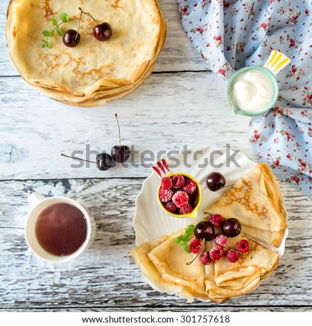 Breakfast: crepes with cherry and raspberry, sour cream and hot tea