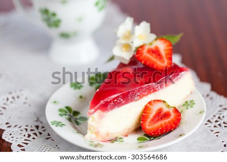 Strawberry cheesecake decorated with jasmine and a half of strawberry