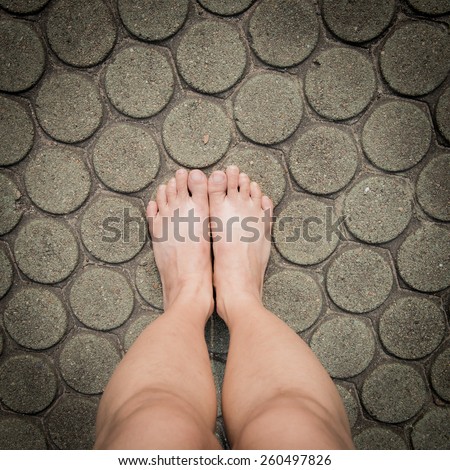 barefoot on patterned paving tiles, cement brick floor background