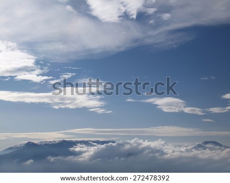 View from height on far mountains under clouds.