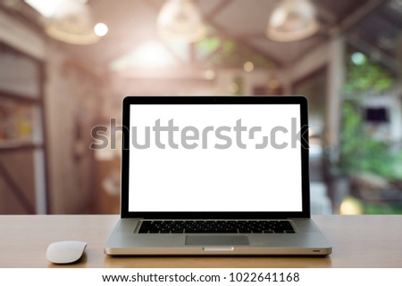 Conceptual workspace,Empty space Wooden Desk with on Laptop screen and wireless mouse in home blurred background at light bokeh.