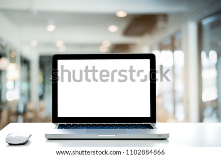 Conceptual workspace,Empty space white desk on Laptop screen and wireless mouse,Interior cafe blurred background of light bokeh.