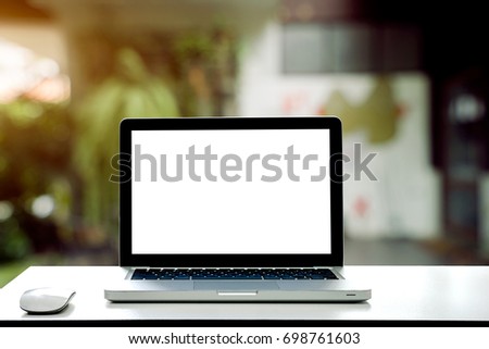 Conceptual workspace,Empty space desk white with on Laptop screen and wireless mouse at blurred background of cafe.