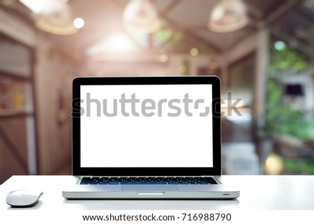 Conceptual workspace,Empty space desk white with on Laptop screen and wireless mouse at blurred background of Cafe.