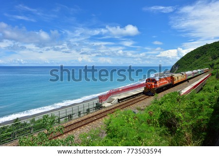 Taitung City, Taiwan, the train traveling along the coastline, a clear blue sky and white clouds and the ocean is a beautiful picture.