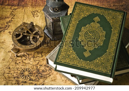 Koran holy book of Muslims with lantern and compass the old map Koran holy book of Muslims with lantern and compass the old map