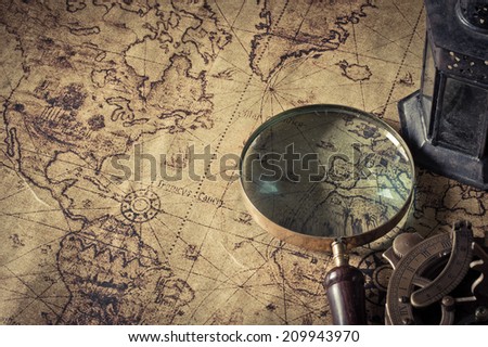 Magnifier with lantern with compass on the  old map  ,picture style vintage