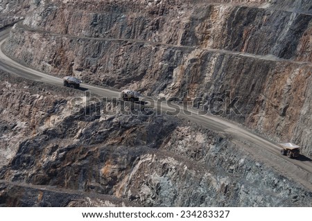 Mining trucks driving in the Kalgoorlie Super Pit gold mine.