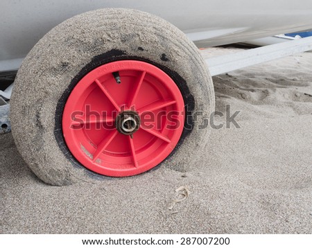 Boat trailer wheel in sand on beach