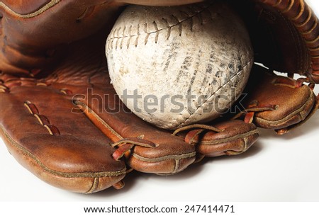 Old worn baseball glove and ball