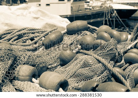Sepia Background with a pile of fishing nets ready to be cast overboard for a new days fishing