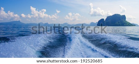 Boat wake prop wash on blue ocean sea in sunny day