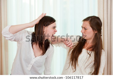 Sisters having an argument and getting physical with a fight.