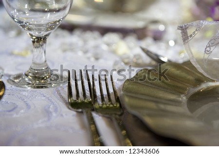 Soft romantic table settings for a wedding, suitable for background of a menu, invitation or wedding brochure/magazine. Shallow DOF.