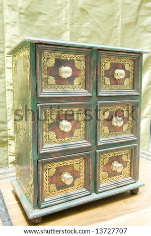 Beautifully restored antique drawer set made of wood with copper insets and knobs.