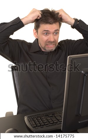 Angry man looking at the computer screen with a look of horror on his face, pulling his hair out. Background is white isolated.