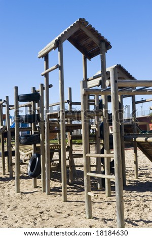 stock-photo-a-park-next-to-the-beach-with-a-play-area-for-kids-containing-a-wooden-jungle-jim-18184630.jpg