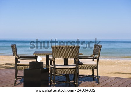 Romantic restaurant setting on a deck on the beach at a luxurious spa.