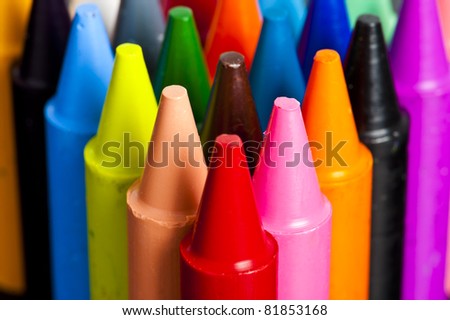 A stack of colorful crayons on an isolated white background.