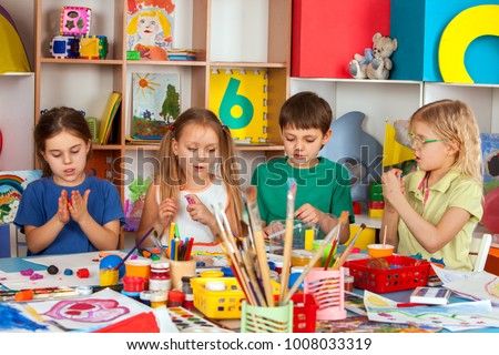 Child dough play in school. Plasticine for children. mold from plasticine in kindergarten .Kids knead modeling clay with hands in preschool. Private school for gifted children.