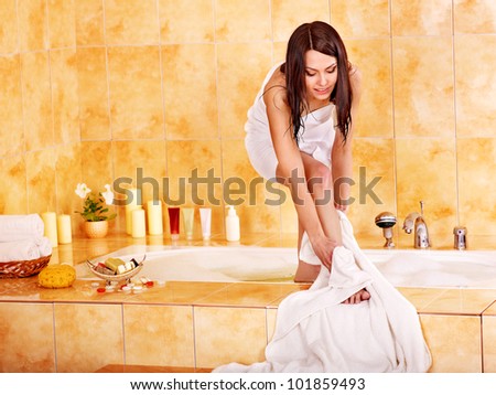 Young woman washing in bath their feet.