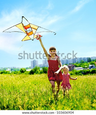 Group children flying kite outdoor. Summer outdoor.