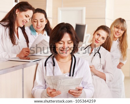 Group doctors standing at reception in hospital.