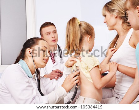 Child with doctor at medical exam.