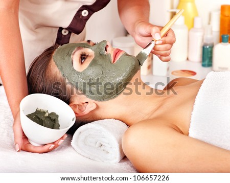 Woman with clay facial mask in beauty spa. Woman with clay facial mask in beauty spa.