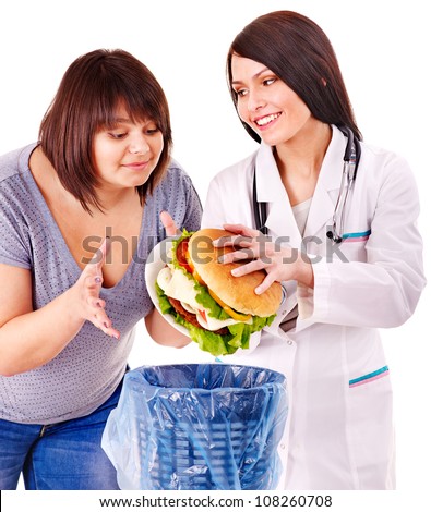 Overweight woman with hamburger and happy doctor.