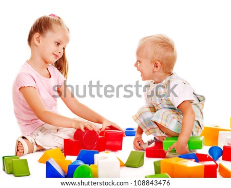 Happy children playing building blocks. Isolated.