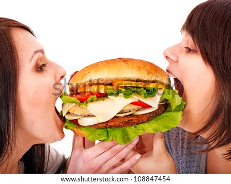 Women eating hamburger. Isolated.