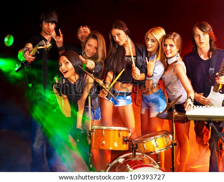 Musical group performance in night club. Lighting effects.