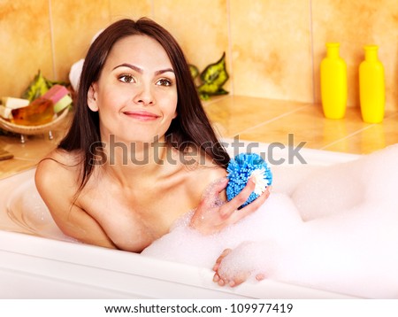 Young smiling woman take bubble  bath.