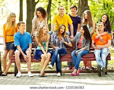 Group people on bench outdoor.