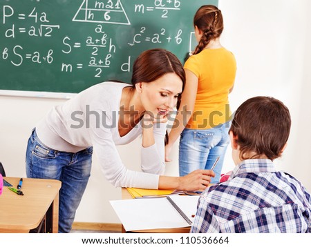 School child with teacher in classroom.