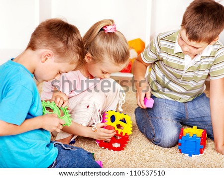 Children in kindergarten stacking block.