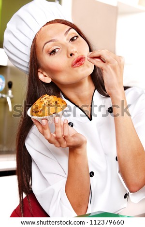 Female chef holding  food at cafeteria .