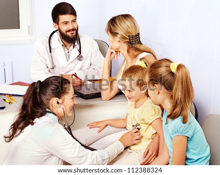 Group female doctor exam children.
