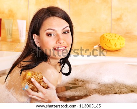 Young nice woman take bubble  bath.