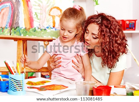 Child with mother painting . Child care.