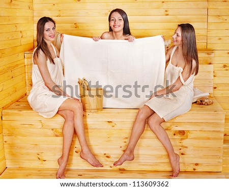 Young woman relaxing in sauna. Copy space.