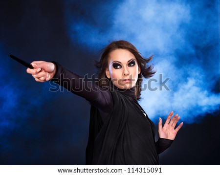 Young woman with magic wand casting spells.