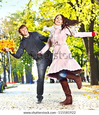 Loving couple on date running autumn outdoor.