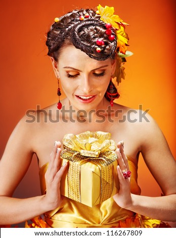 Woman with  autumn hairstyle  holding gift box.